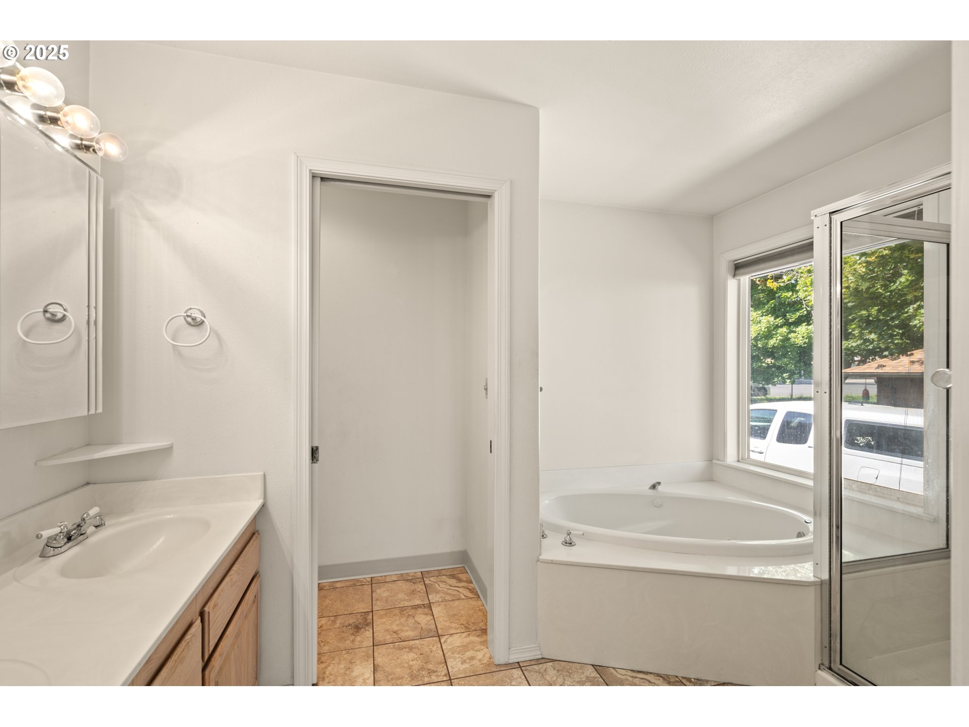 1837 Southwest Athens Avenue Pendleton, OR 97801 - Photo 20 of 42 a bathroom with a tub sink vanity and a mirror