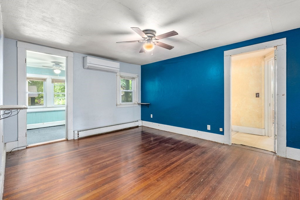 32 Undine Circle Springfield, MA 01109 - Photo 13 of 38 an empty room with wooden floor chandelier fan and windows