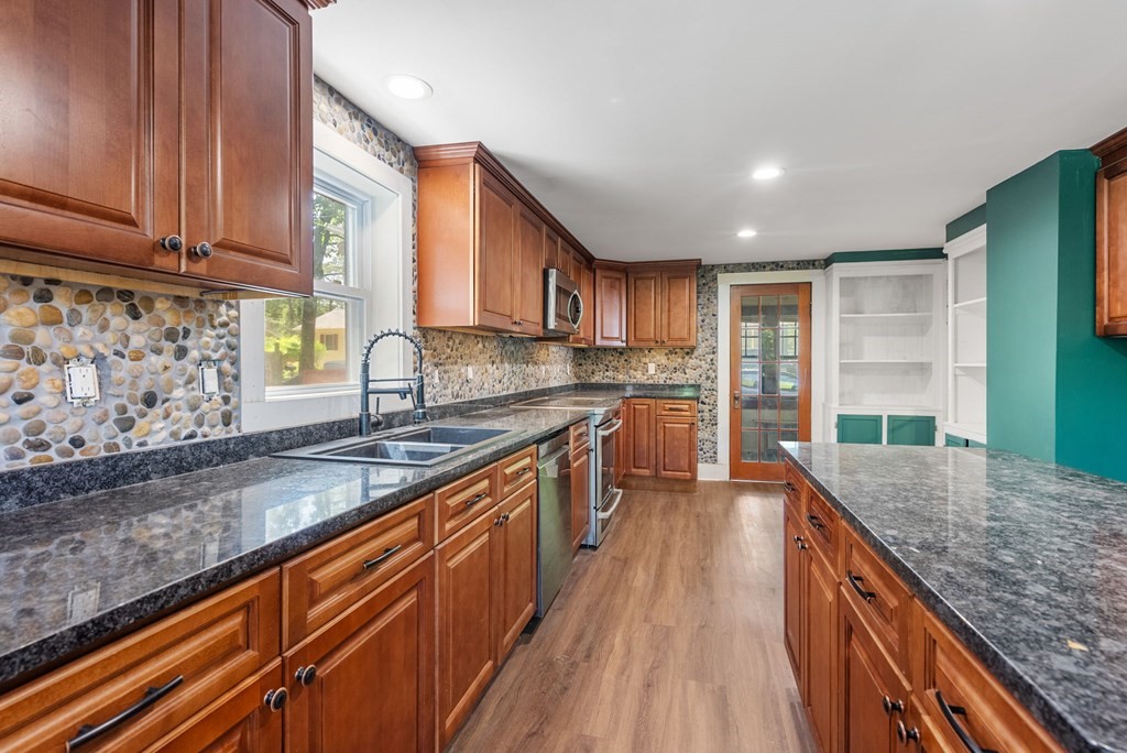 32 Undine Circle Springfield, MA 01109 - Photo 2 of 38 a kitchen with stainless steel appliances granite countertop wooden cabinets a sink and dishwasher