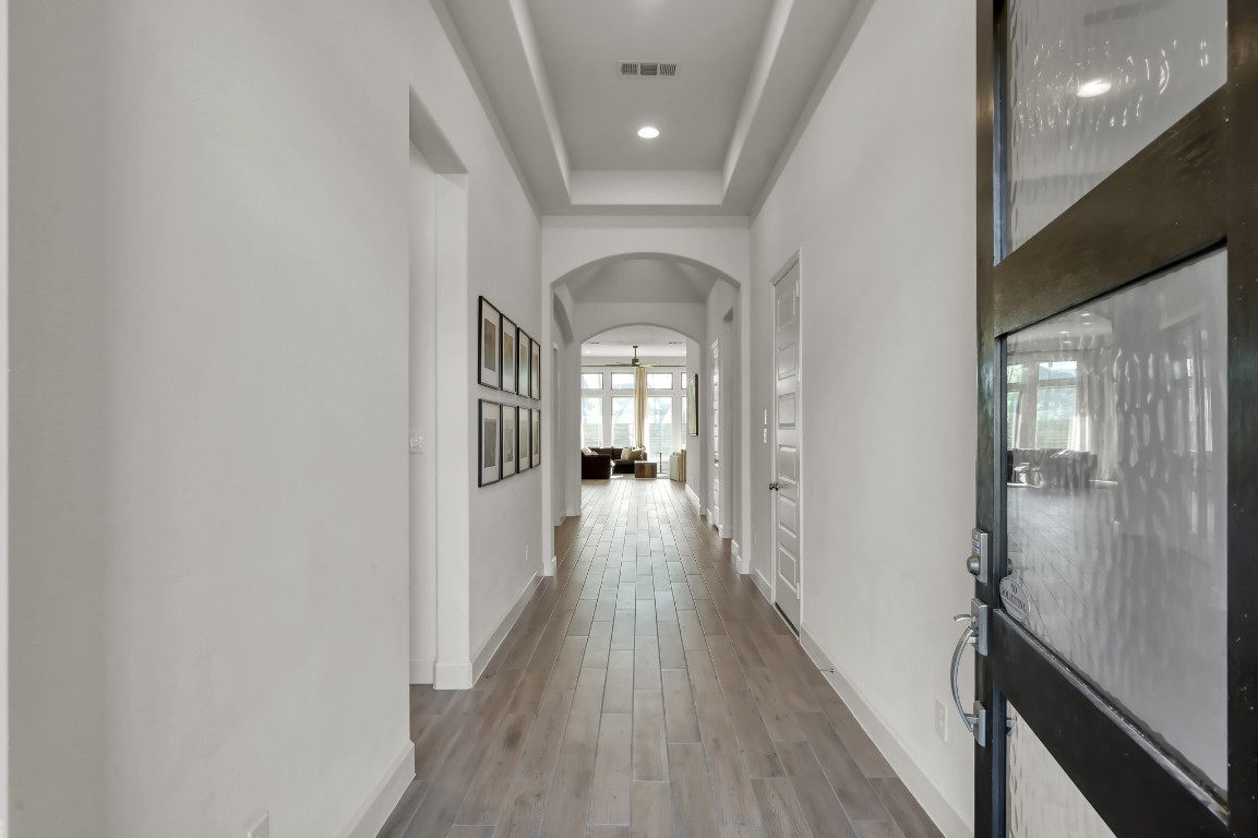 17801 Parnassum Path Conroe, TX 77302 - Photo 2 of 32 The grand entry and extended hallway create a strong, welcoming first impression.