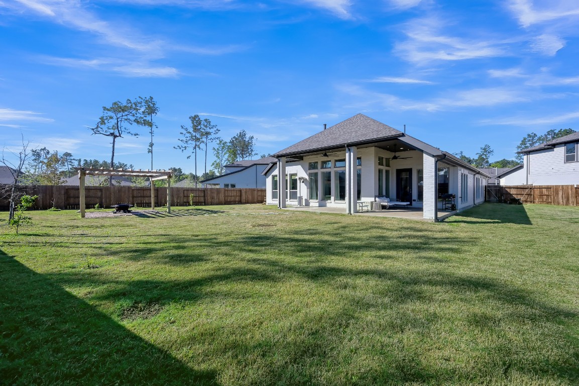 17801 Parnassum Path Conroe, TX 77302 - Photo 28 of 32 Backyard space like this is hard to find—giving you options most homes simply don’t offer.