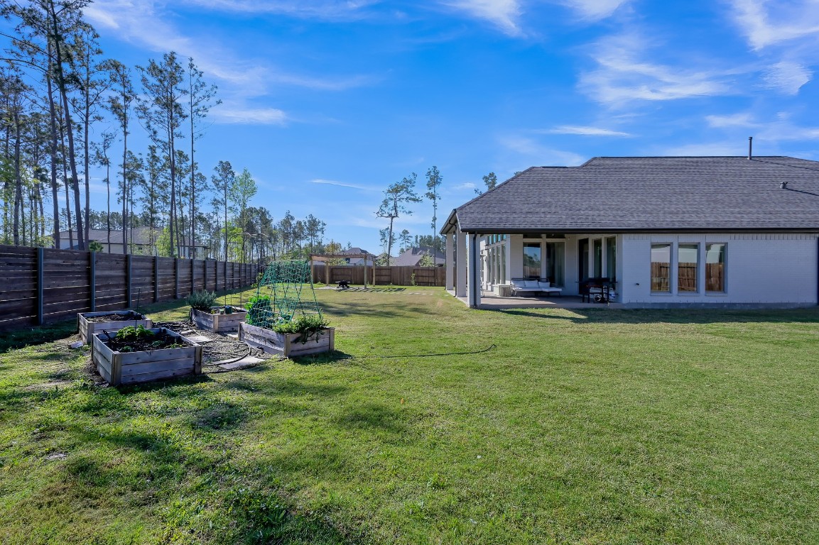 17801 Parnassum Path Conroe, TX 77302 - Photo 29 of 32 Gazebo set within the backyard, surrounded by space for gardening, relaxing, and enjoying the outdoors.