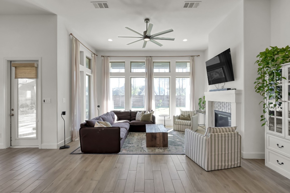 17801 Parnassum Path Conroe, TX 77302 - Photo 5 of 32 Floor-to-ceiling windows wrap the living room in light