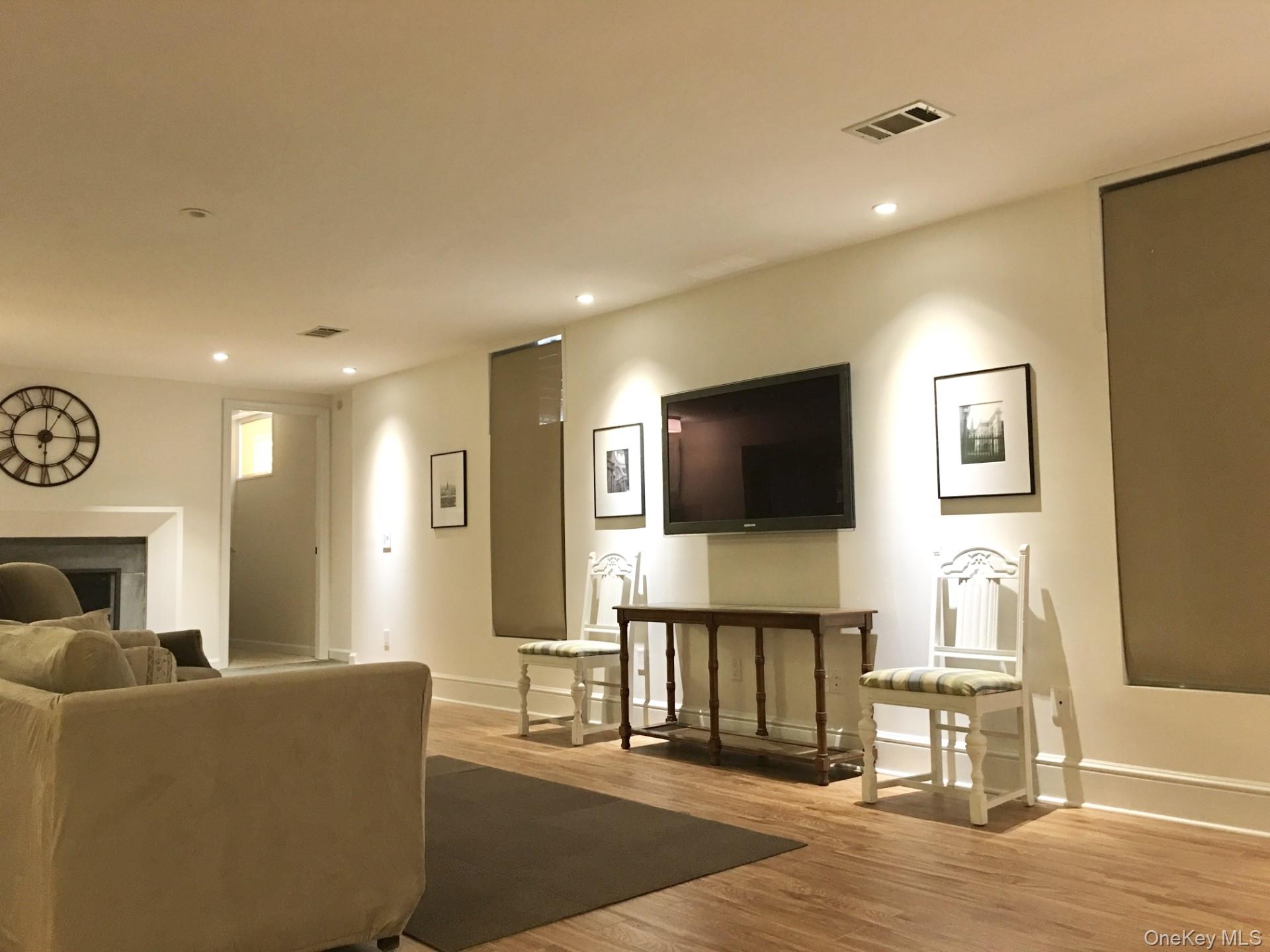 9 Cedar Hill Road Pound Ridge, NY 10576 - Photo 15 of 21 Fully Finished Lower Level. Rec Room with wood-burning fireplace.