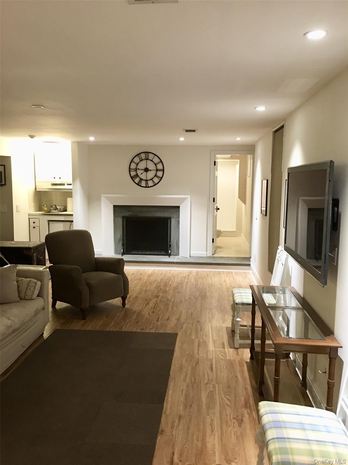 9 Cedar Hill Road Pound Ridge, NY 10576 - Photo 17 of 21 Fully Finished Lower Level. Rec Room with wood-burning fireplace.