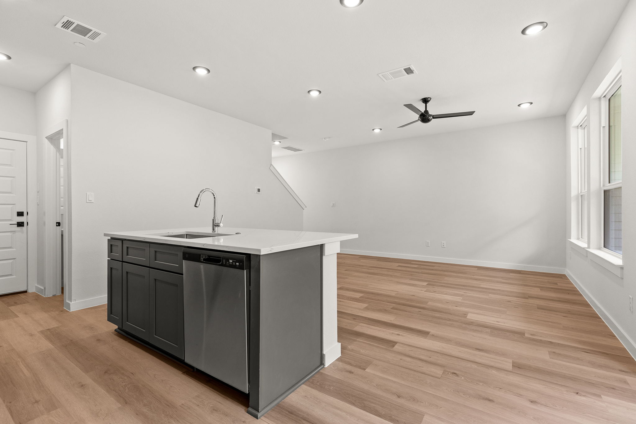 2600 Gattis School Road, Unit 1002 Round Rock, TX 78664 - Photo 5 of 40 A pristine open-concept space features a well-appointed kitchen island, sleek appliances, and durable wood flooring.