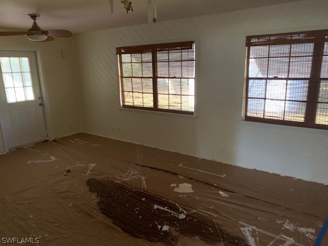 140 Riverview Road Fort Myers, FL 33905 - Photo 4 of 5 an empty room with wooden floor and windows