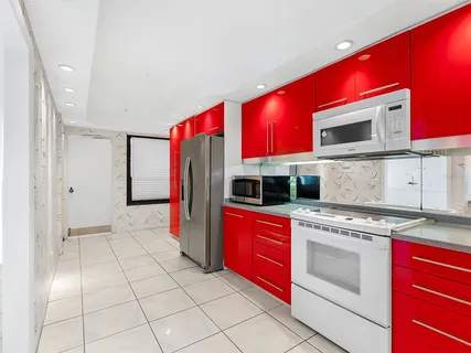 a kitchen with stainless steel appliances a sink stove and cabinets