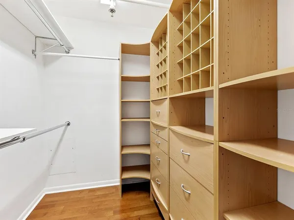 a view of an empty room and wooden floor