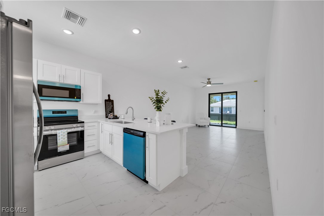 936-938 Homestead Road South Lehigh Acres, FL 33974 - Photo 2 of 9 a kitchen with a sink stove and refrigerator
