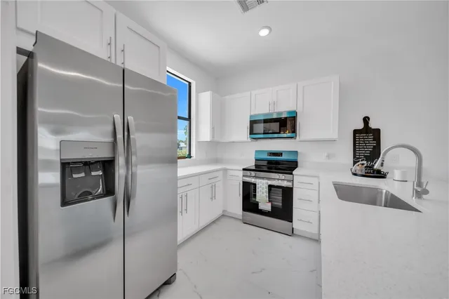 a kitchen with cabinets and stainless steel appliances