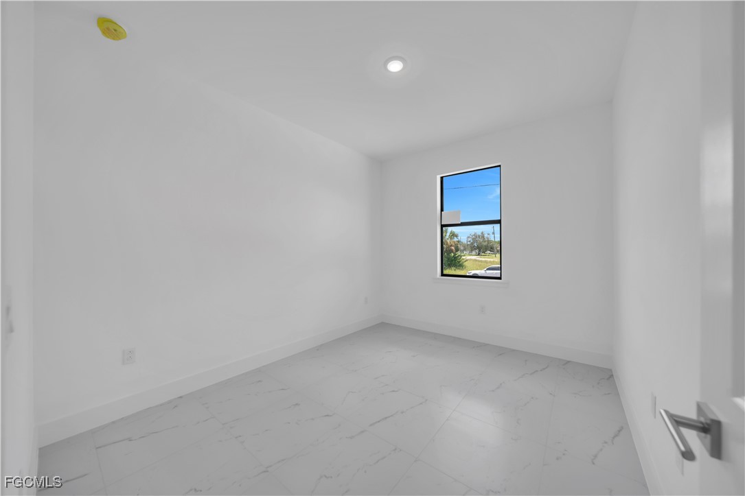 936-938 Homestead Road South Lehigh Acres, FL 33974 - Photo 5 of 9 a view of an empty room with a window