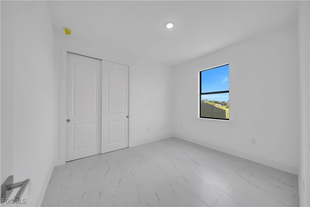 936-938 Homestead Road South Lehigh Acres, FL 33974 - Photo 6 of 9 a view of an empty room with a window