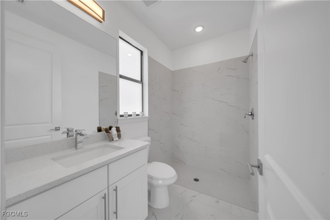 936-938 Homestead Road South Lehigh Acres, FL 33974 - Photo 8 of 9 a bathroom with a sink a toilet and shower