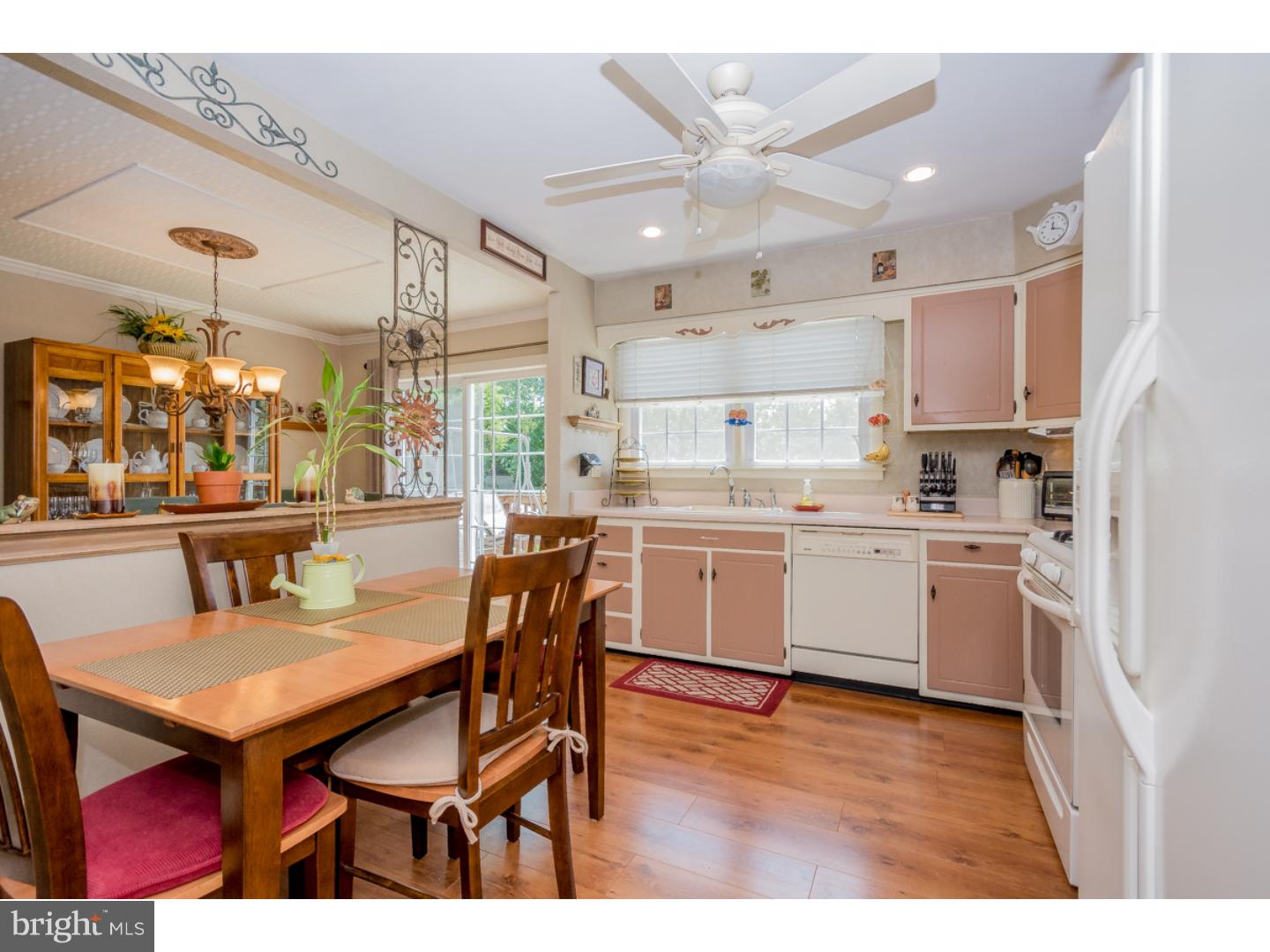 5 Constitution Road Laurel Springs, NJ 08021 - Photo 8 of 25 a kitchen with a table chairs refrigerator and cabinets