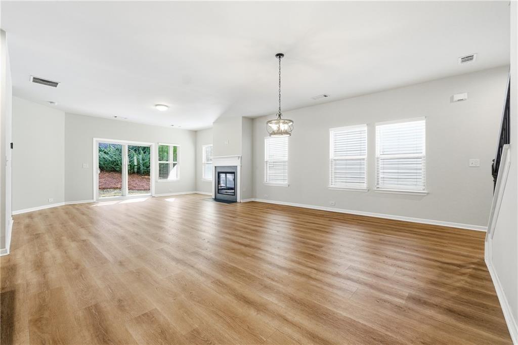 2719 Morgan Spring Trail Buford, GA 30519 - Photo 25 of 46 a view of an empty room with window and wooden floor