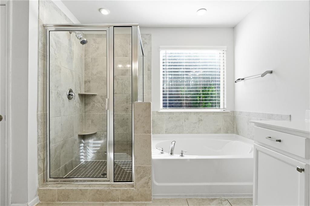 2719 Morgan Spring Trail Buford, GA 30519 - Photo 36 of 46 a bathroom with a bathtub and a shower