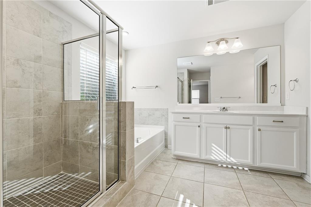 2719 Morgan Spring Trail Buford, GA 30519 - Photo 6 of 46 a bathroom with a double vanity sink a mirror and a shower