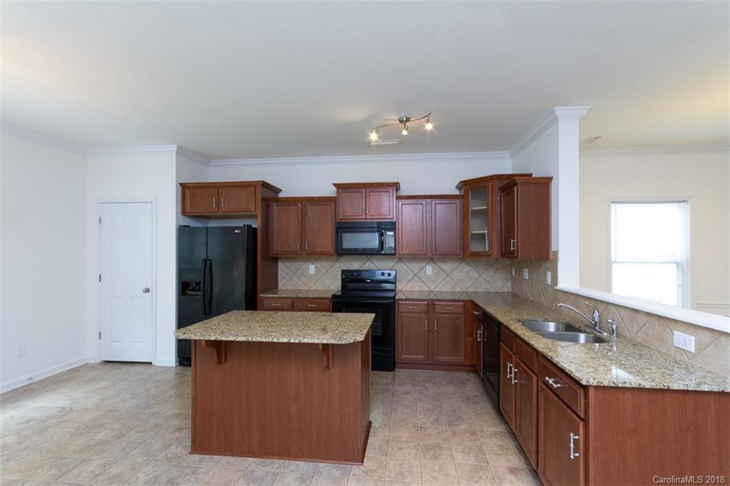 9609 Fernspray Road Charlotte, NC 28213 - Photo 13 of 30 a kitchen with stainless steel appliances granite countertop a sink stove and refrigerator