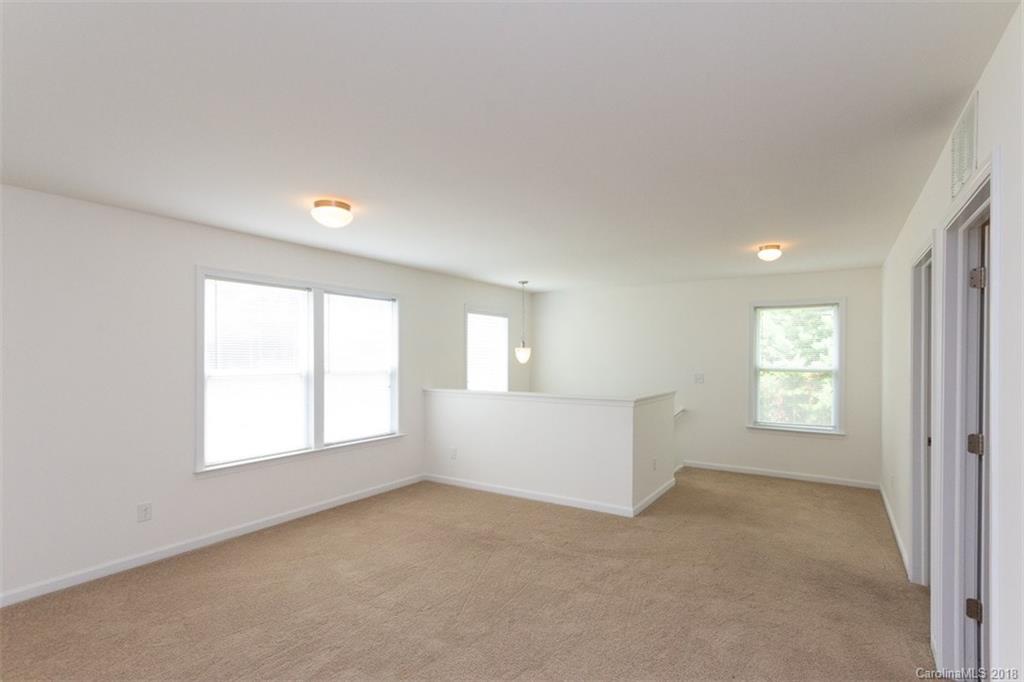 9609 Fernspray Road Charlotte, NC 28213 - Photo 18 of 30 an empty room with windows and cabinet