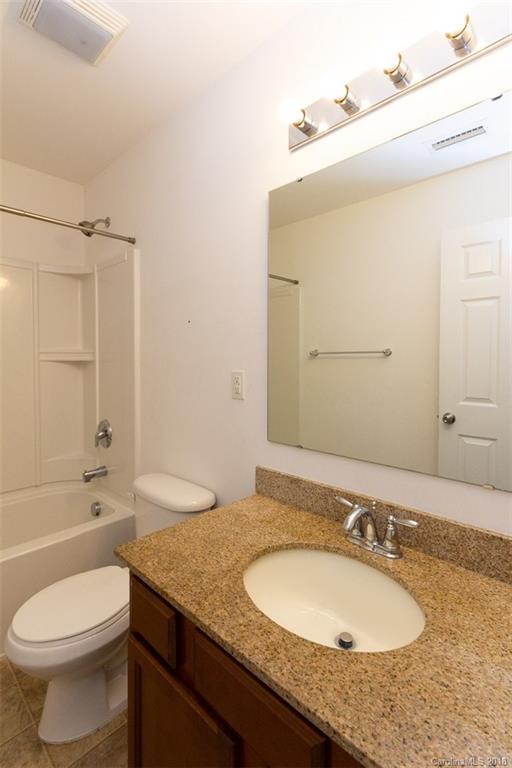 9609 Fernspray Road Charlotte, NC 28213 - Photo 19 of 30 a bathroom with a granite countertop sink and a mirror