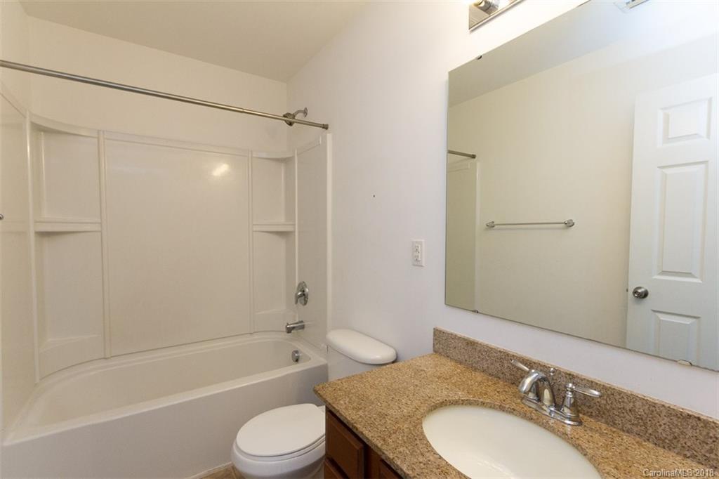 9609 Fernspray Road Charlotte, NC 28213 - Photo 20 of 30 a bathroom with a granite countertop toilet sink and shower