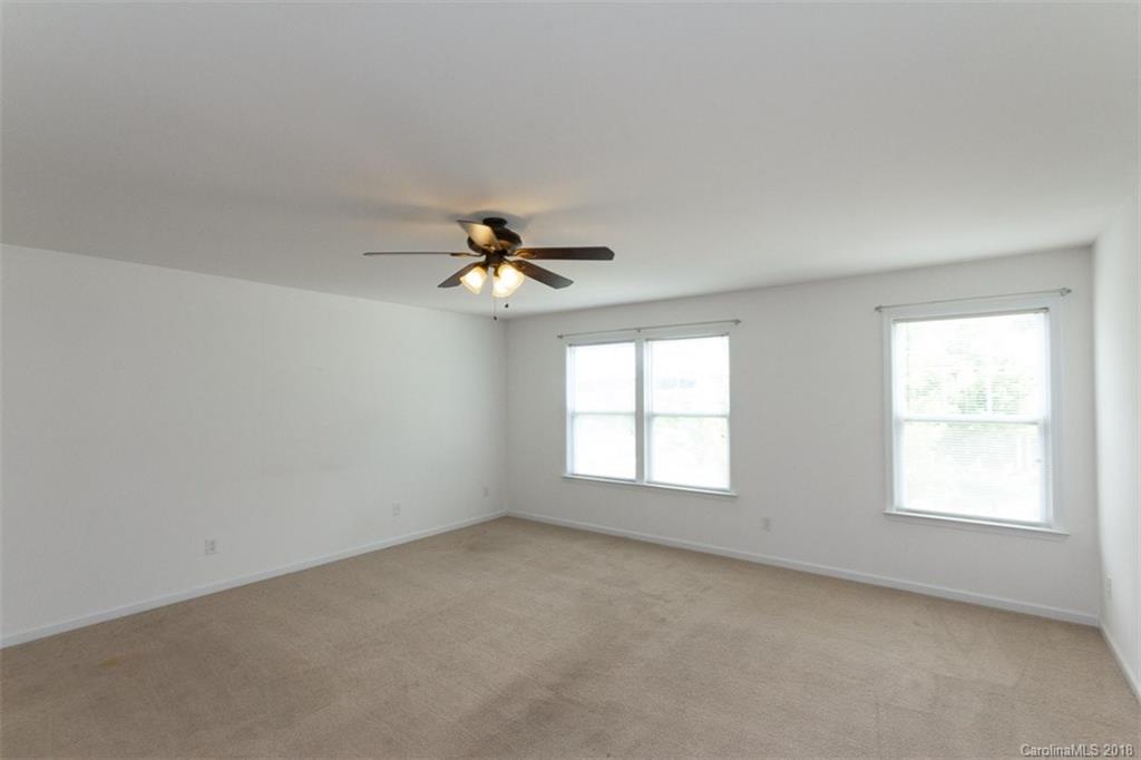 9609 Fernspray Road Charlotte, NC 28213 - Photo 23 of 30 an empty room with windows and fan