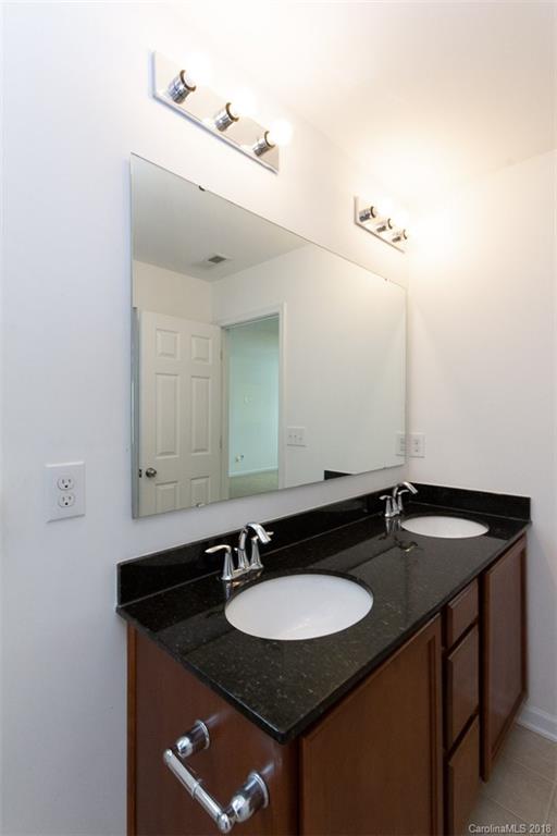 9609 Fernspray Road Charlotte, NC 28213 - Photo 26 of 30 a bathroom with a granite countertop sink and a mirror