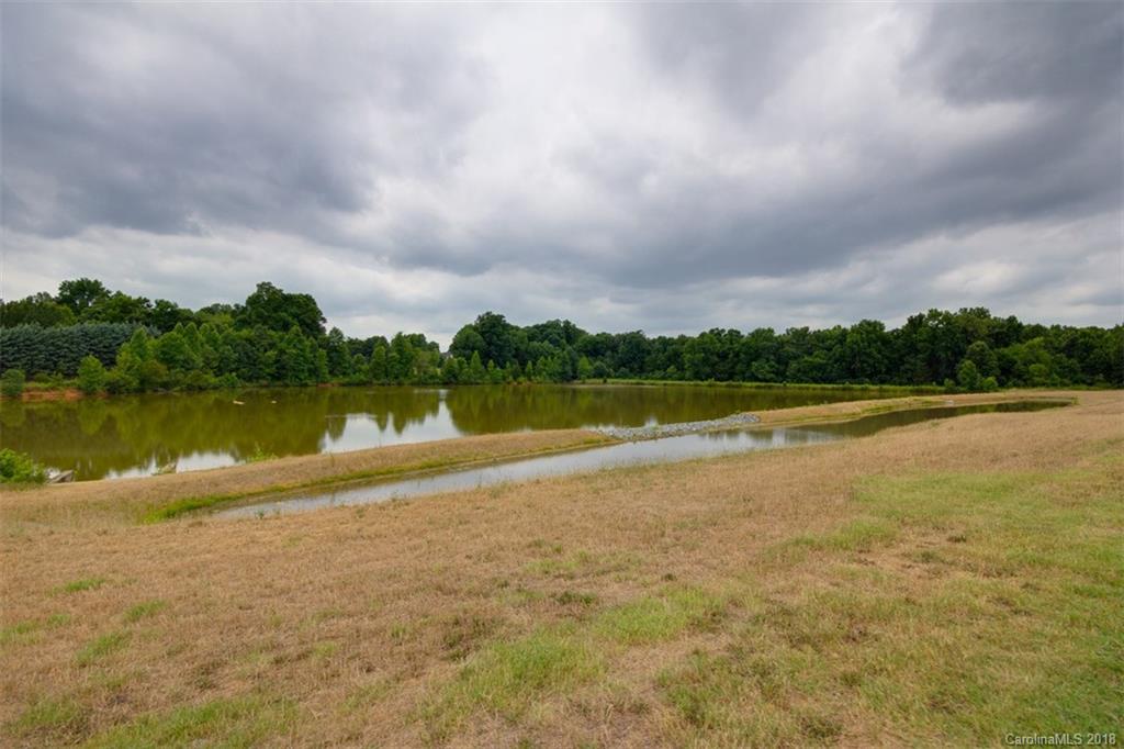 9609 Fernspray Road Charlotte, NC 28213 - Photo 5 of 30 a view of a lake with houses in the back