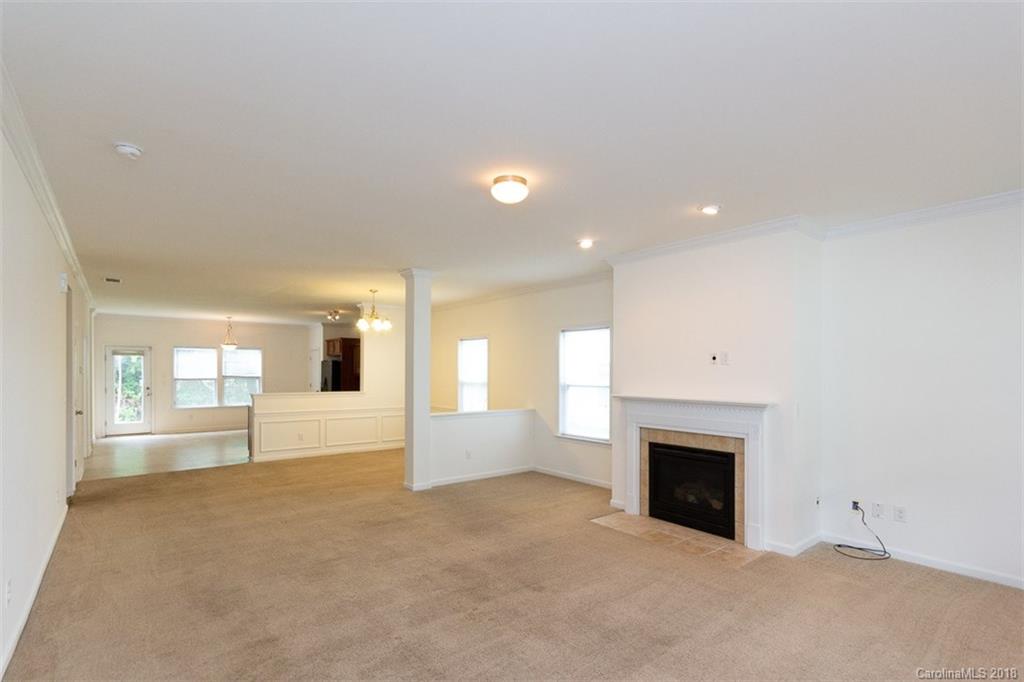 9609 Fernspray Road Charlotte, NC 28213 - Photo 7 of 30 an empty room with fireplace and windows