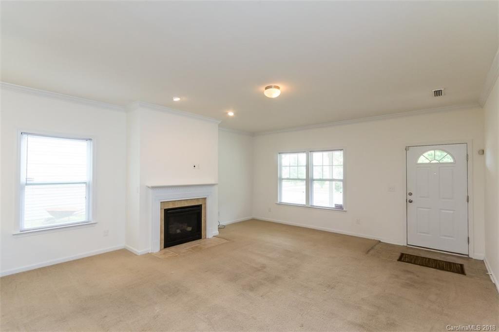 9609 Fernspray Road Charlotte, NC 28213 - Photo 8 of 30 an empty room with fireplace and windows