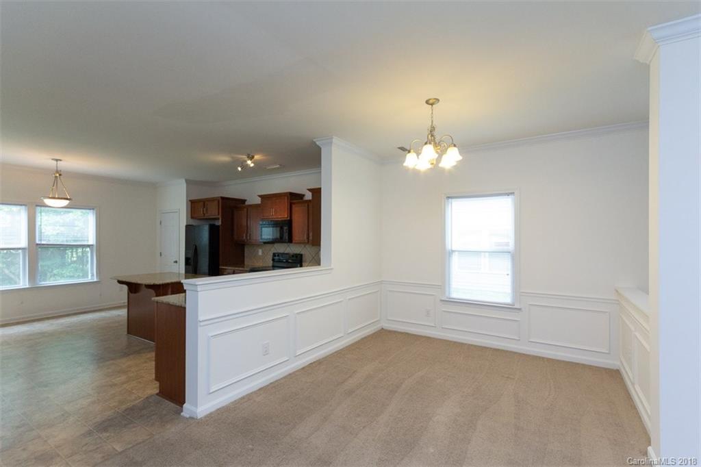 9609 Fernspray Road Charlotte, NC 28213 - Photo 9 of 30 wooden floor in an empty room with a window