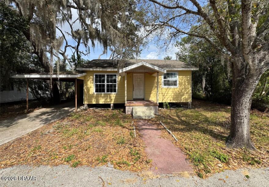 4718 2nd Street Sebring, FL 33870 - Photo 1 of 17 a front view of a house with a yard and garage