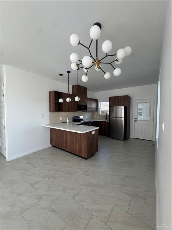 104 Sunflower Street, Unit 1 Mission, TX 78572 - Photo 11 of 21 a kitchen with stainless steel appliances a stove top oven and cabinets