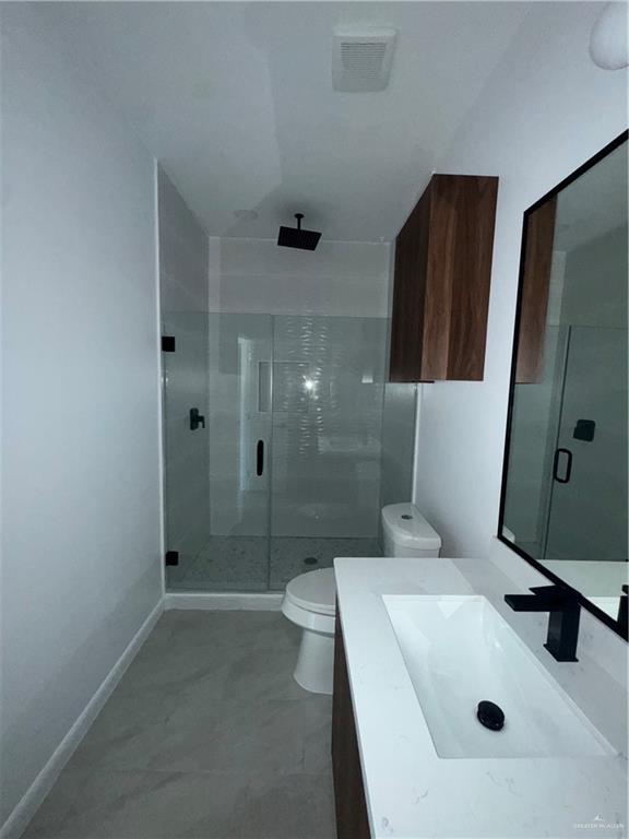 104 Sunflower Street, Unit 1 Mission, TX 78572 - Photo 18 of 21 a bathroom with a sink a toilet and shower