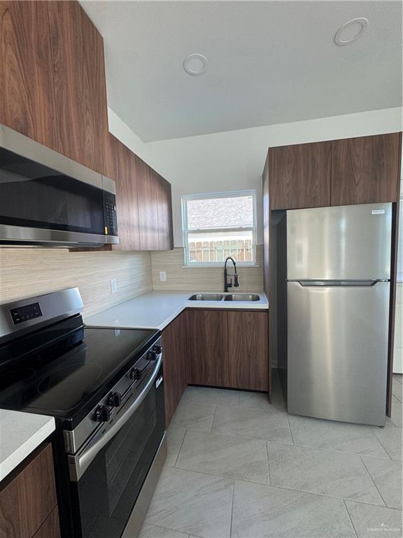 104 Sunflower Street, Unit 1 Mission, TX 78572 - Photo 8 of 21 a kitchen with a refrigerator and a sink