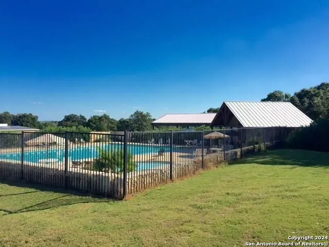 a view of swimming pool with large trees