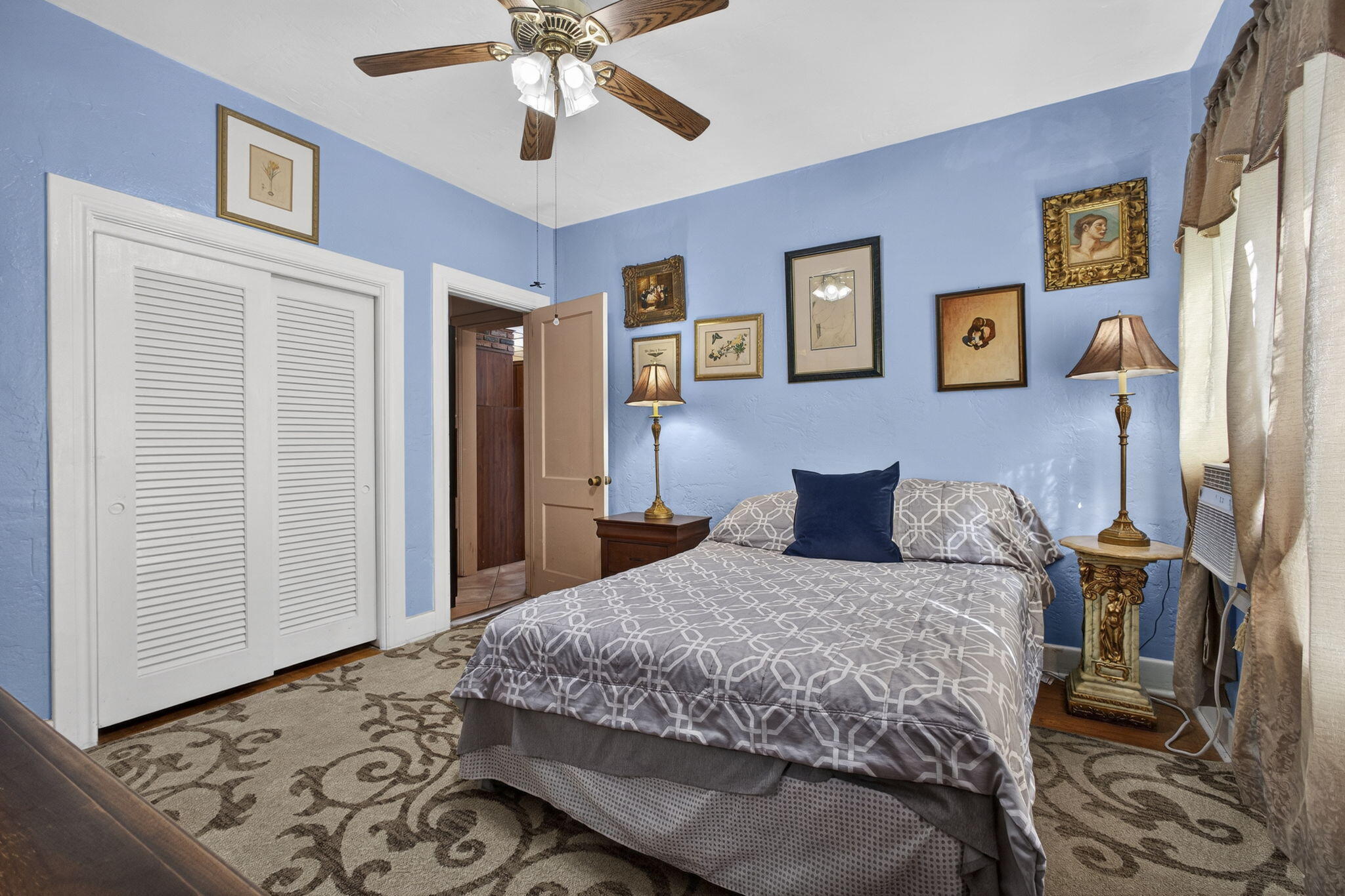 445 29th Street West Palm Beach, FL 33407 - Photo 16 of 61 a bedroom with a bed and a chandelier