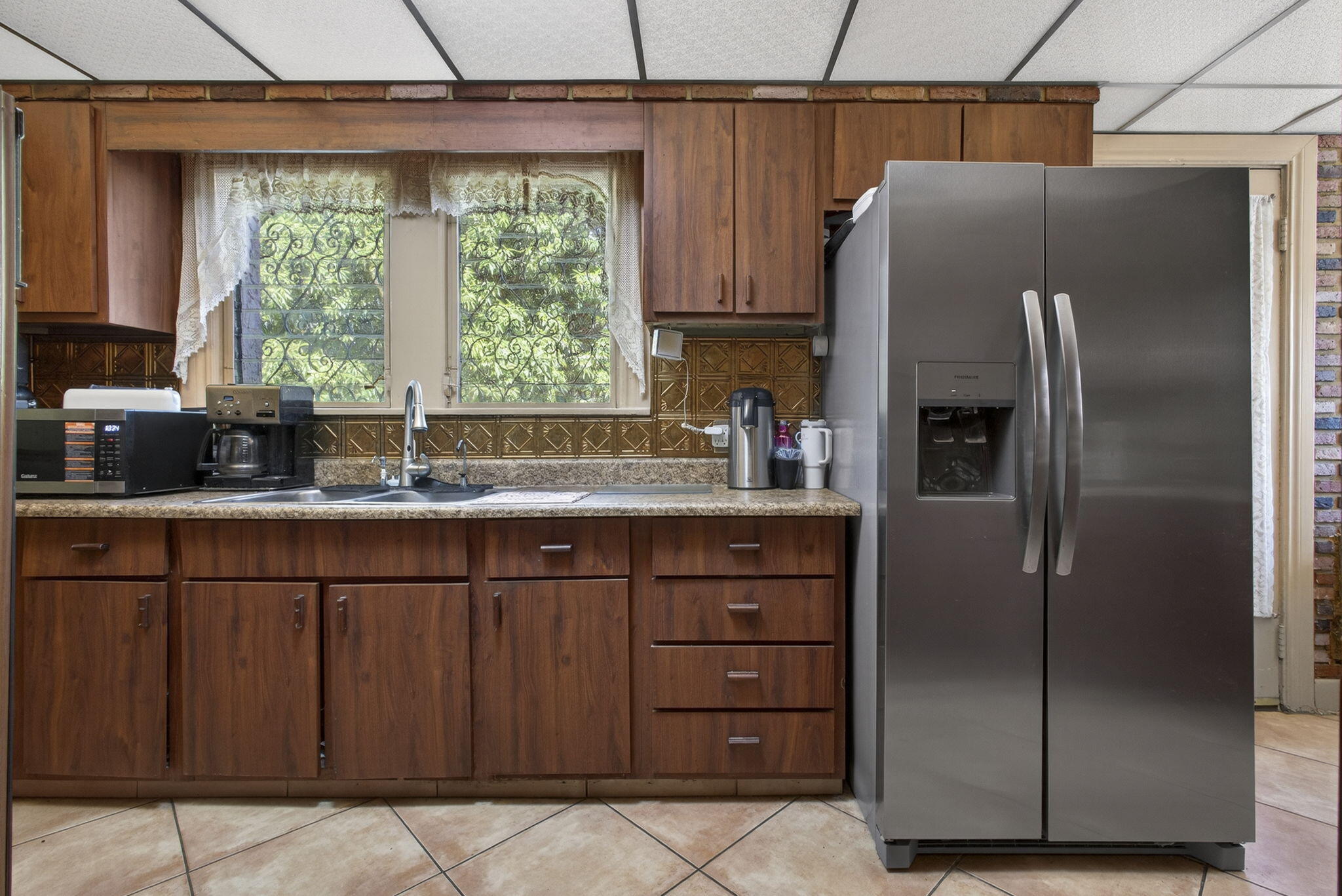 445 29th Street West Palm Beach, FL 33407 - Photo 17 of 61 a kitchen with stainless steel appliances granite countertop a refrigerator and a sink