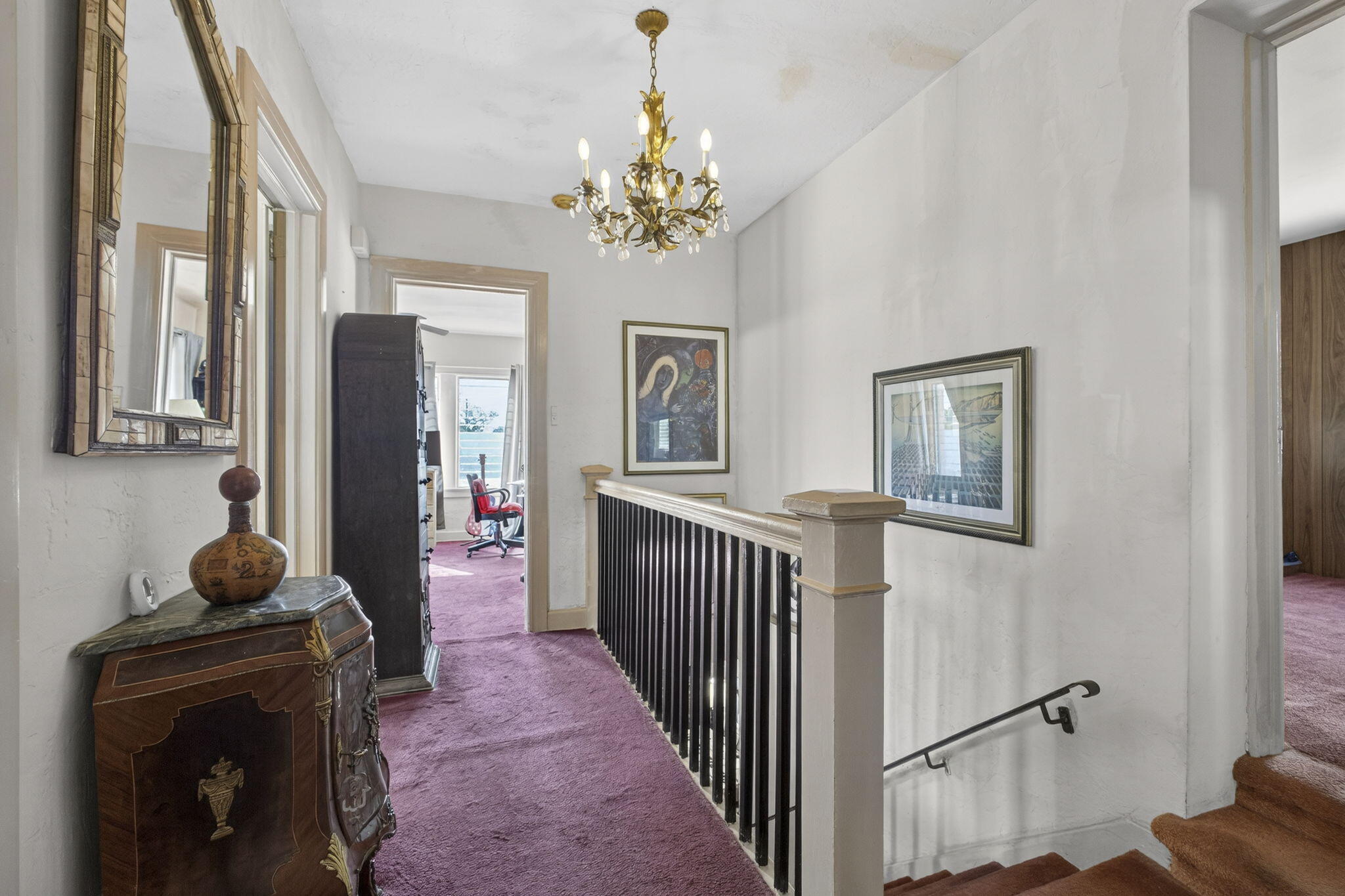445 29th Street West Palm Beach, FL 33407 - Photo 32 of 61 a view of a hallway to a livingroom with furniture wooden floor windows and a chandelier