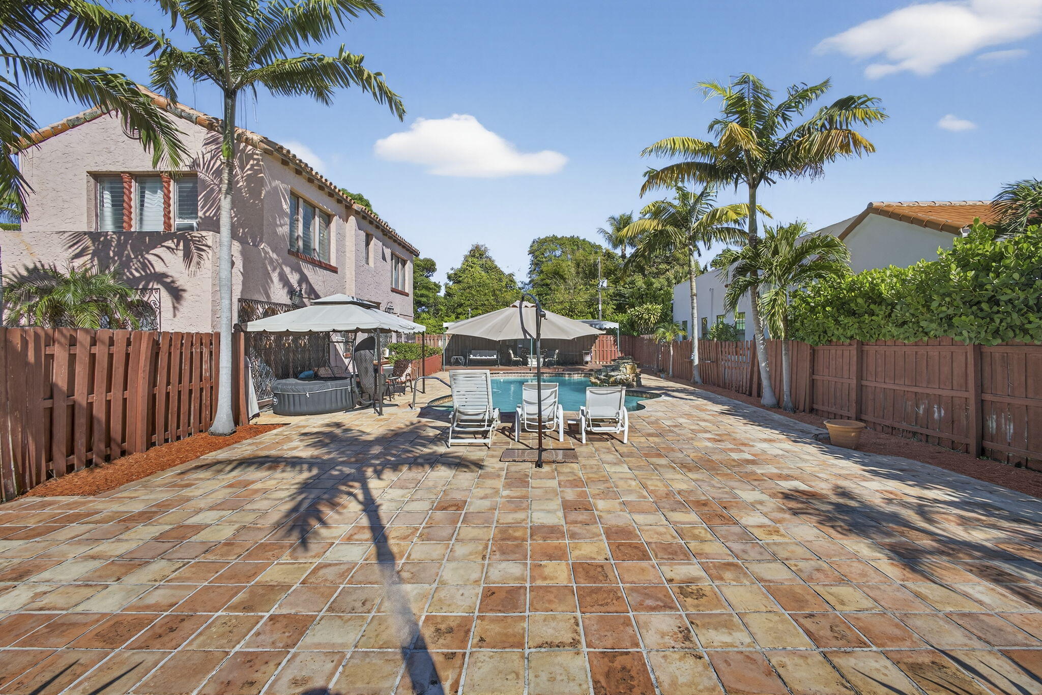445 29th Street West Palm Beach, FL 33407 - Photo 48 of 61 a view of a backyard with a patio and a garden