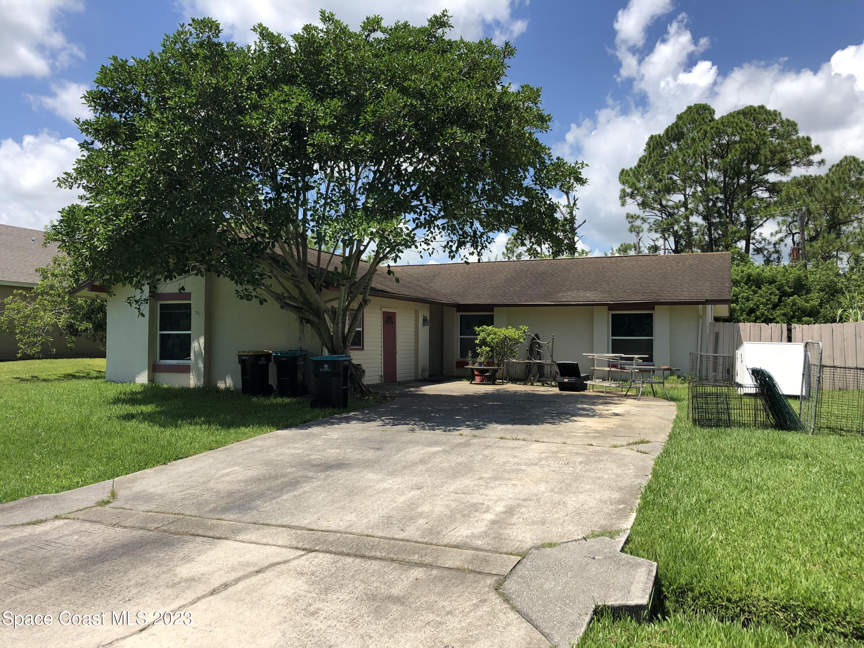750 Fletcher Road Southeast Palm Bay, FL 32909 - Photo 1 of 12 a view of house with outdoor entertaining spaces