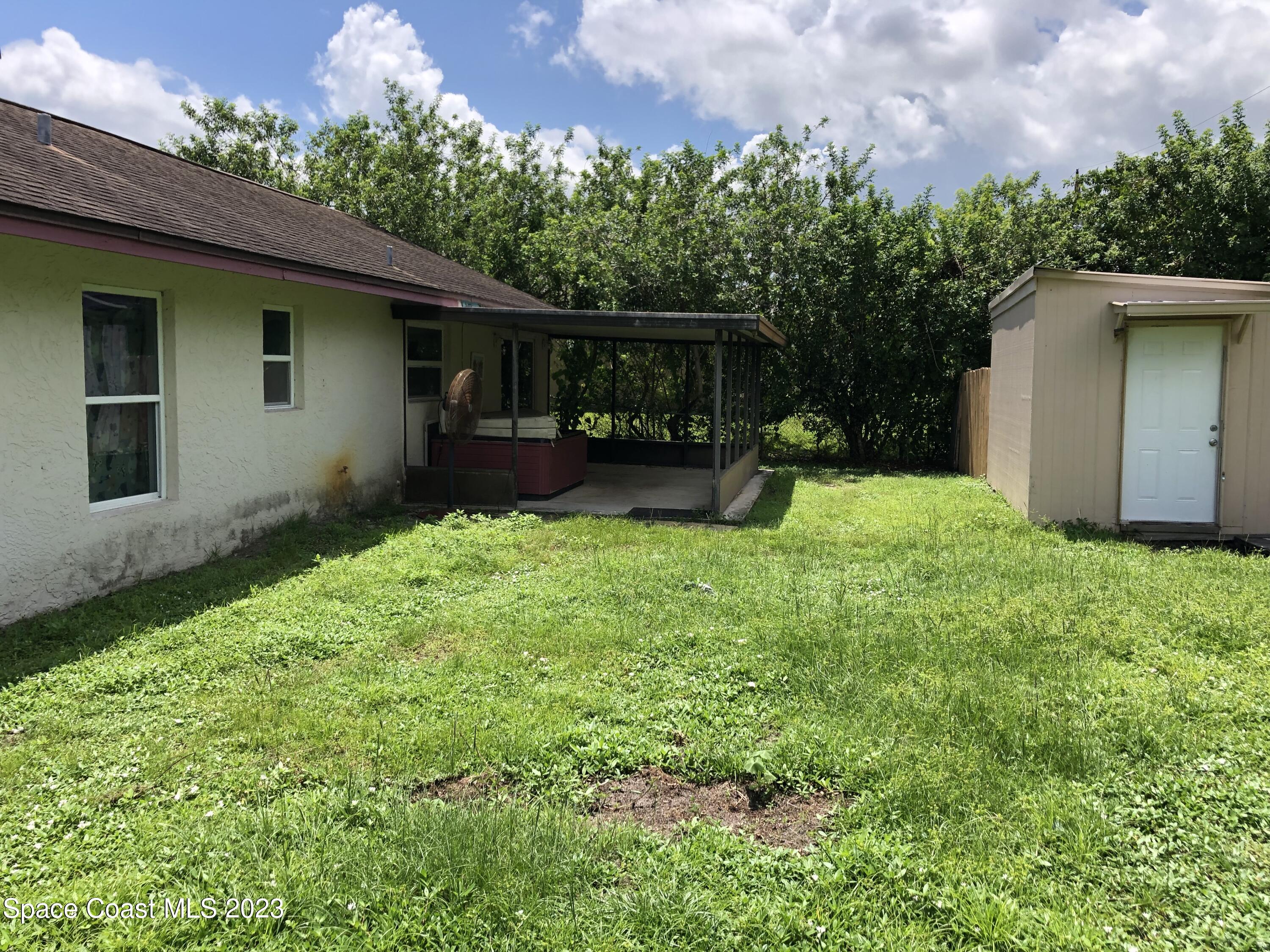 750 Fletcher Road Southeast Palm Bay, FL 32909 - Photo 11 of 12 a view of a backyard with a garden and plants