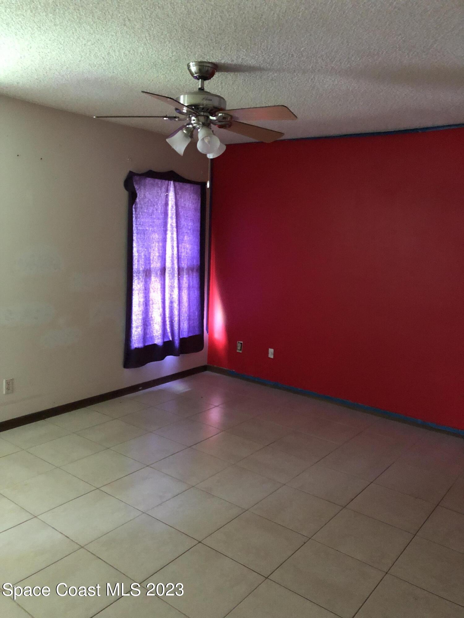 750 Fletcher Road Southeast Palm Bay, FL 32909 - Photo 6 of 12 a view of an empty room with a window