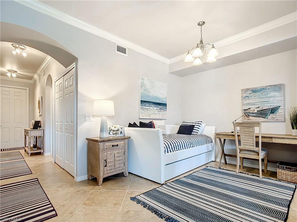 9715 Acqua Court, Unit 127 Naples, FL 34113 - Photo 11 of 50 a living room with furniture and a chandelier