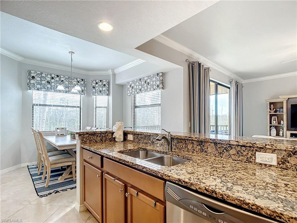 9715 Acqua Court, Unit 127 Naples, FL 34113 - Photo 14 of 50 a bathroom with a granite countertop sink and a large mirror