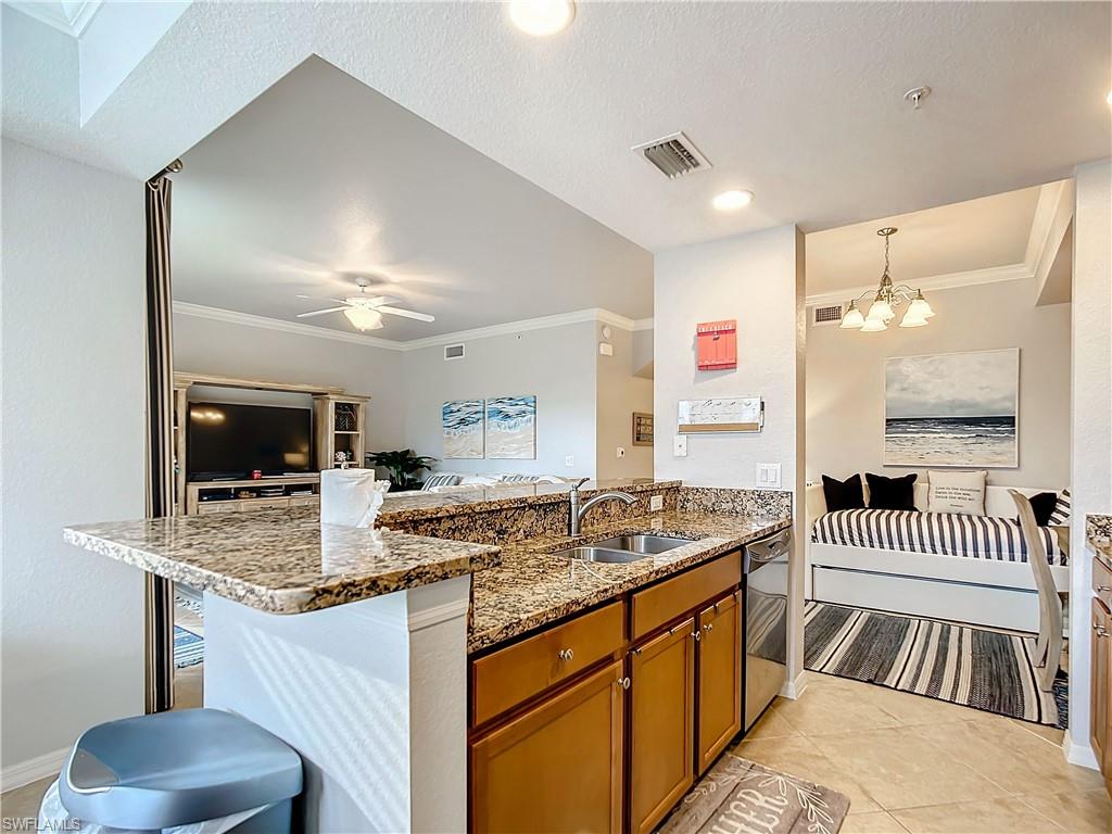 9715 Acqua Court, Unit 127 Naples, FL 34113 - Photo 18 of 50 a bathroom with a granite countertop sink a mirror and shower