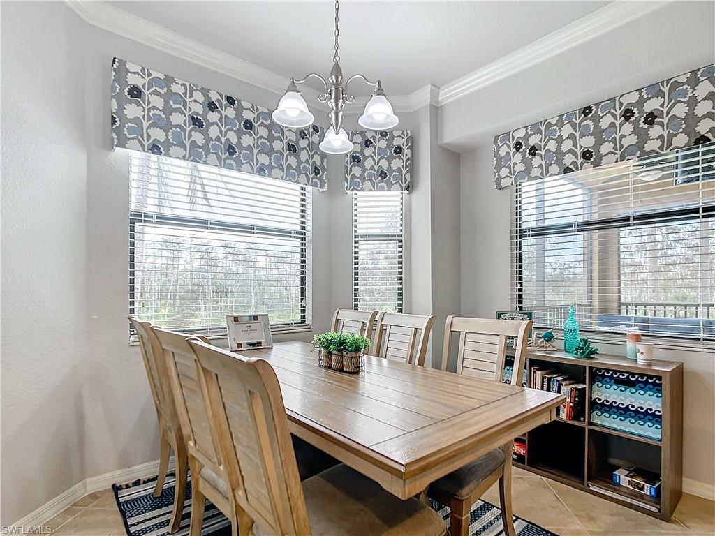 9715 Acqua Court, Unit 127 Naples, FL 34113 - Photo 19 of 50 a dining room with furniture and window