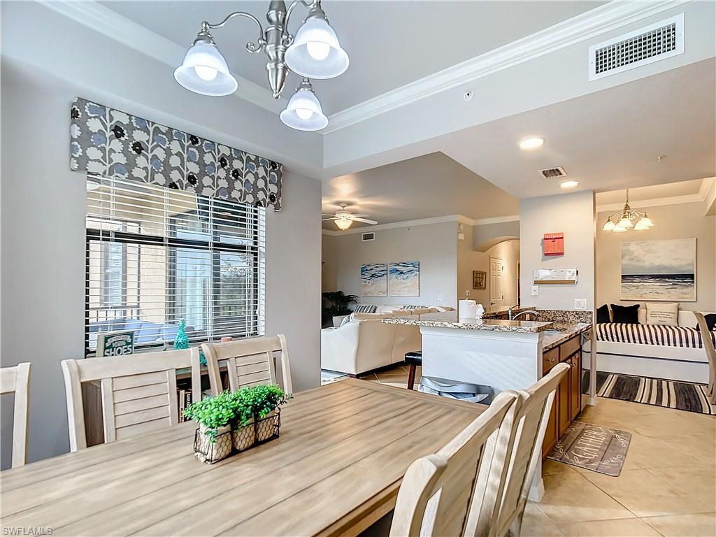 9715 Acqua Court, Unit 127 Naples, FL 34113 - Photo 21 of 50 a living room with furniture and a large window