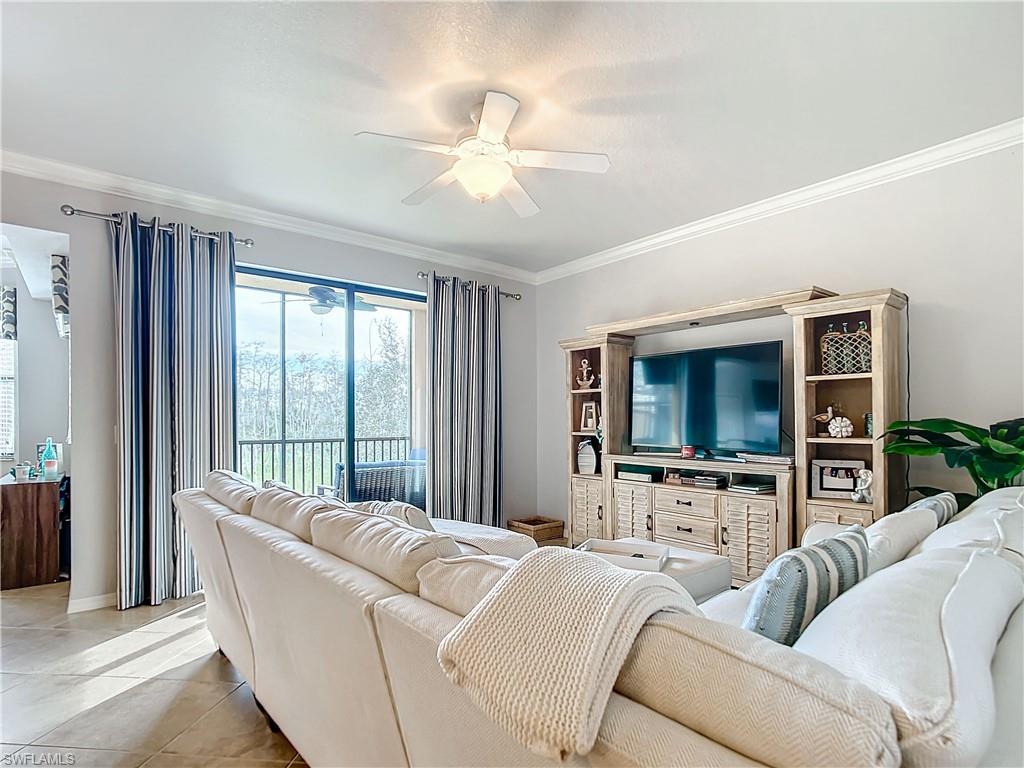 9715 Acqua Court, Unit 127 Naples, FL 34113 - Photo 24 of 50 a living room with furniture a flat screen tv and a large window